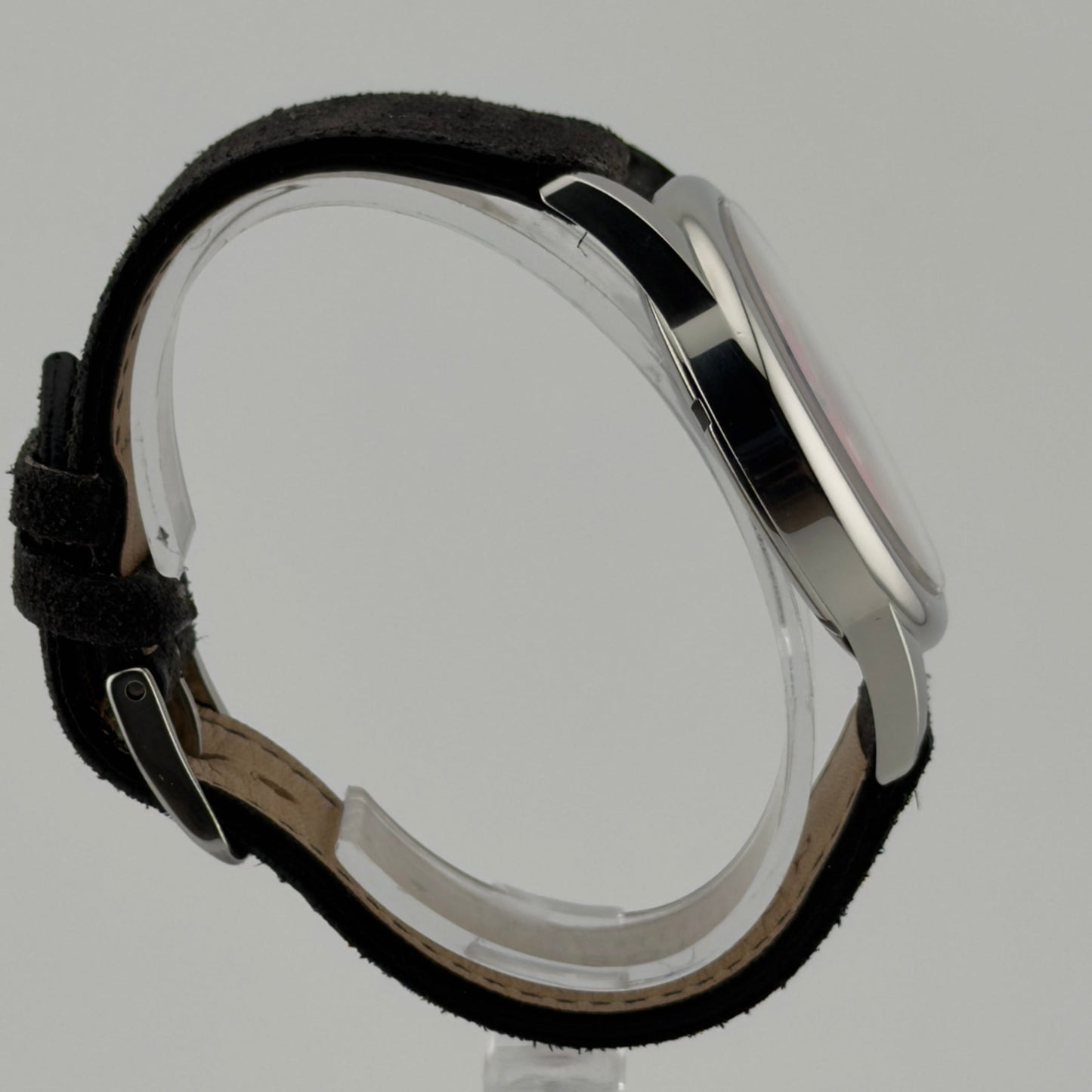 Wristwatch with black leather strap and silver case on a gray background