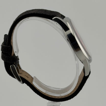 Wristwatch with black leather strap and silver case on a gray background