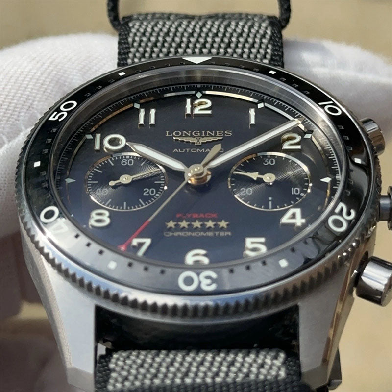 Longines watch with a detailed face and textured strap on a neutral background