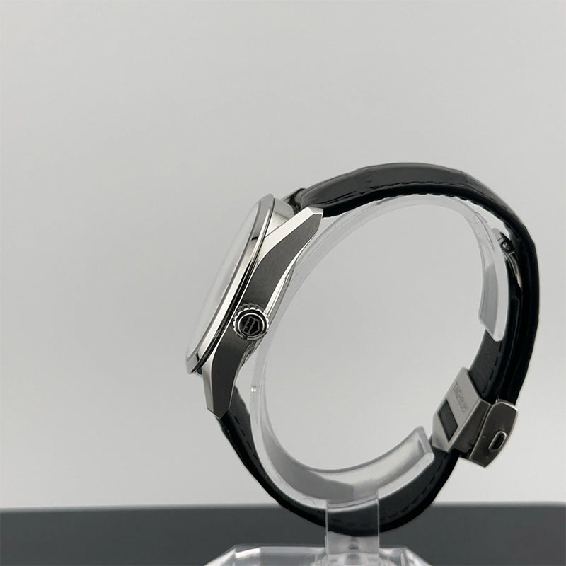 watch with black band on a clear stand against a gray background